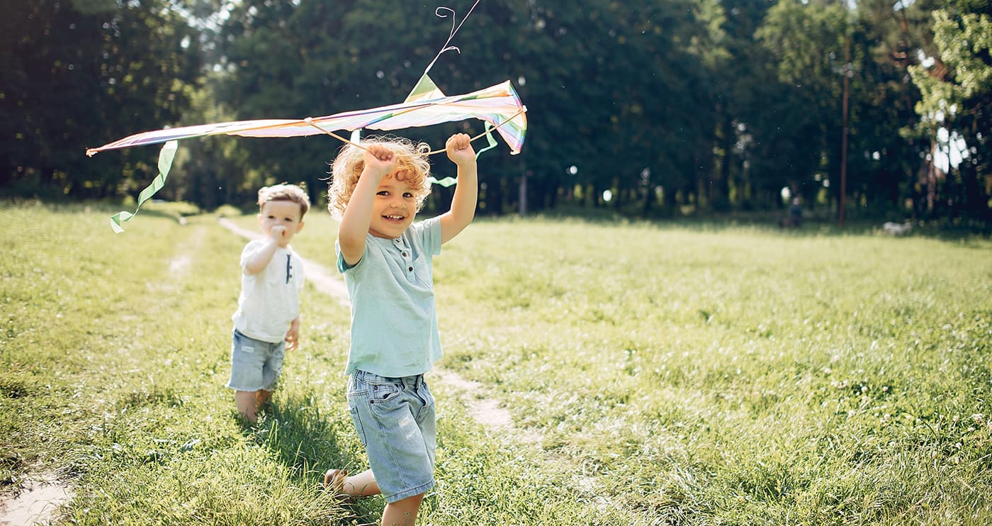 cute little child summer field with kite min